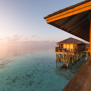 Beautiful tropical Maldives resort hotel and island with beach and sea on sky sunset for holiday vacation background concept - Boost up color Processing.